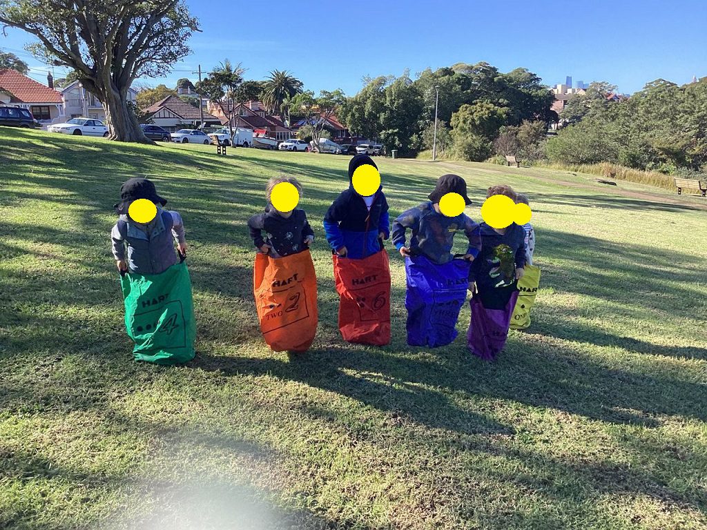 Toddlers on community park excursion developing gross motor skills at Drummoyne early learning centre